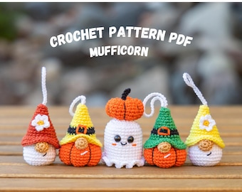 May include: Crochet pattern PDF for five Halloween-themed amigurumi: a ghost, a gnome with a red hat, a gnome with a yellow hat, a gnome with a green hat, and a pumpkin. The pattern is called "Mufficorn".