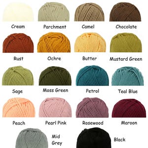 May include: A collection of eighteen yarn balls arranged in a grid, each labeled with its color name: Cream, Parchment, Camel, Chocolate, Rust, Ochre, Butter, Mustard Green, Sage, Moss Green, Petrol, Teal Blue, Peach, Pearl Pink, Rosewood, Maroon, Mid Grey, and Black.