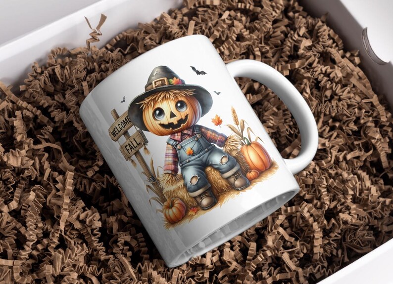 May include: White ceramic mug with a colorful illustration of a scarecrow with a pumpkin head. The scarecrow is sitting on a bale of hay and holding a pumpkin. The mug has the words "Welcome Fall" on a sign.