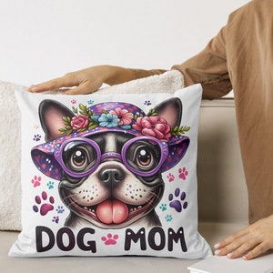May include: White throw pillow with a cartoon image of a French bulldog wearing a purple and pink flower hat and sunglasses. The text "DOG MOM" is printed below the image.