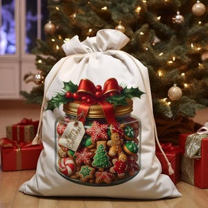 May include: White Christmas gift bag with a red ribbon and a glass jar filled with gingerbread cookies. The jar has a gold lid and a tag that says "Merry Christmas".