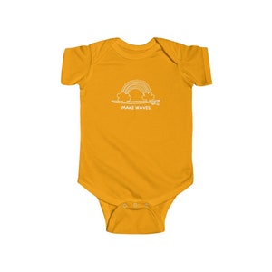 May include: A yellow baby onesie with a white outline of a rainbow over a surfboard and the text "MAKE WAVES".