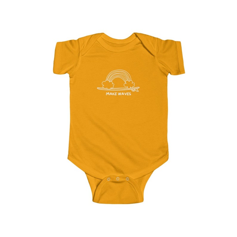May include: A yellow baby onesie with a white outline of a rainbow over a surfboard and the text "MAKE WAVES".