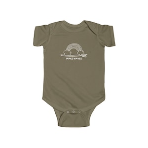May include: A light green baby onesie with a white outline of a rainbow over a surfboard and the text "MAKE WAVES".