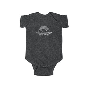 May include: A dark grey baby onesie with a white graphic of a rainbow over a surfboard with the text "MAKE WAVES".