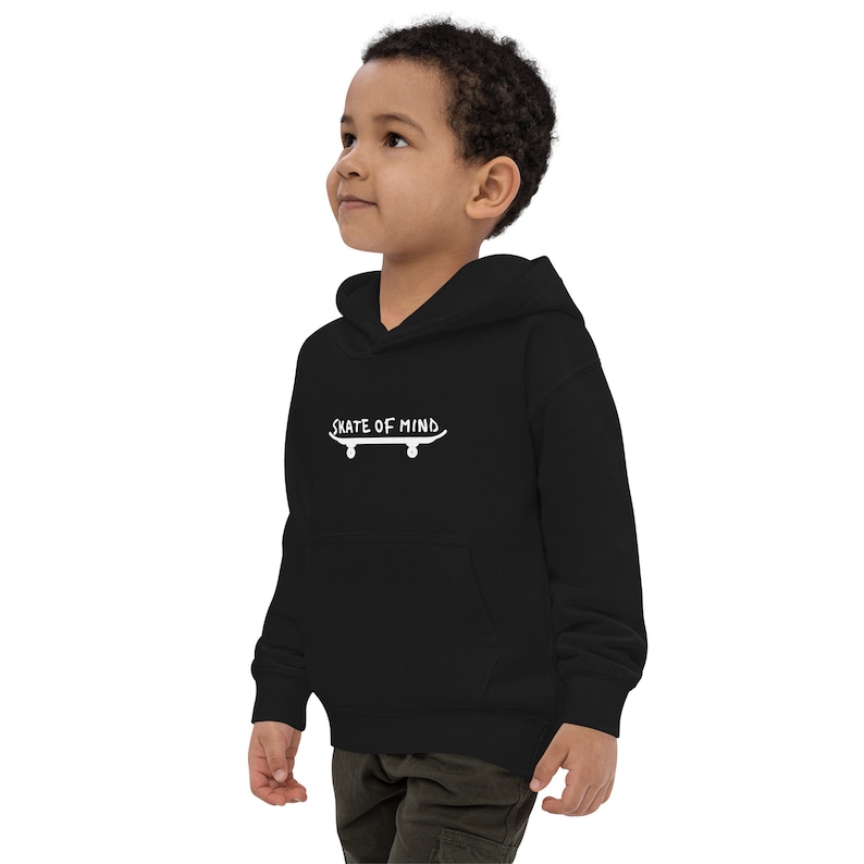 May include: Black hooded sweatshirt for kids with a white graphic of a skateboard and the text "Skate of Mind".