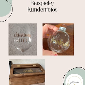 May include: A clear glass wine glass with gold text reading Christina Lillet, a clear glass Christmas ornament with gold text reading Rinkuth, and a rectangular wooden box with a glass lid featuring the gold text cards on the front.