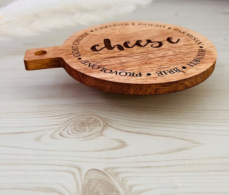 This adorable miniature charcuterie board will give any kitchen or dining area a sweet and personalized touch. These are small and Measure 5” Wide x 6.75” Tall.