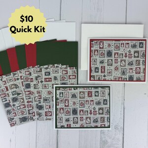 May include: A stationery set featuring greeting cards and envelopes with a repeating pattern of postage stamp-style illustrations of Christmas ornaments, trees, and Santa Claus in red, dark green, and grey. Includes a yellow starburst label with $10 Quick Kit text.
