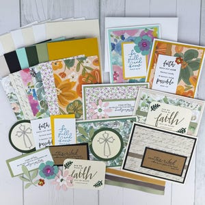 May include: A collection of handmade greeting cards and crafting supplies. The cards feature floral designs and inspirational quotes. Includes patterned paper, embellishments, and envelopes. The color palette includes white, green, yellow, and floral patterns.