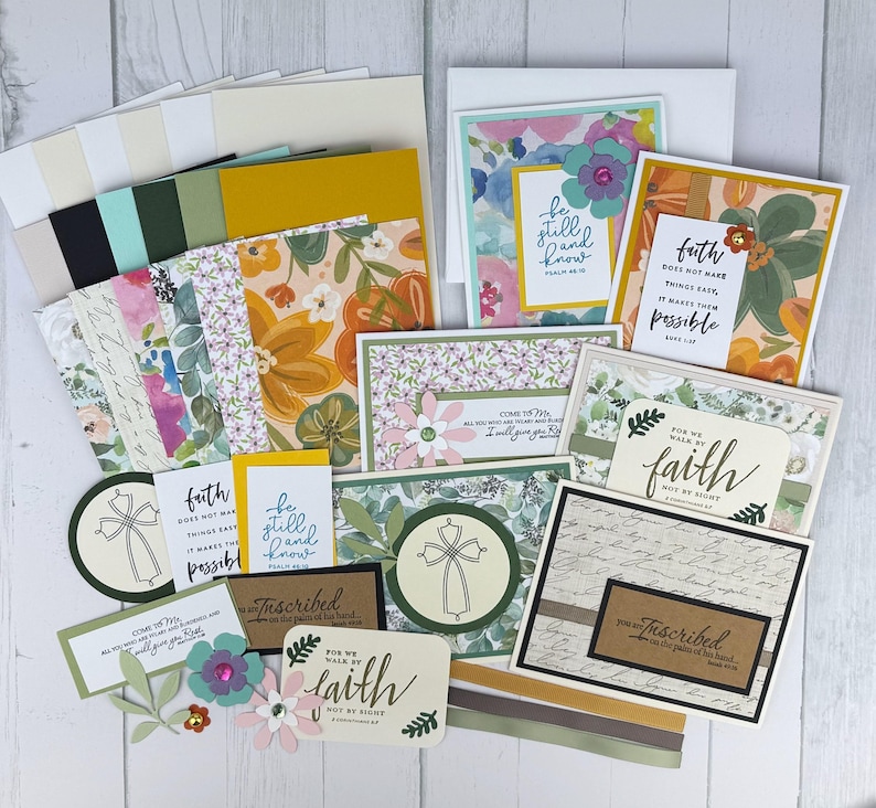 May include: A collection of handmade greeting cards and crafting supplies. The cards feature floral designs and inspirational quotes. Includes patterned paper, embellishments, and envelopes. The color palette includes white, green, yellow, and floral patterns.