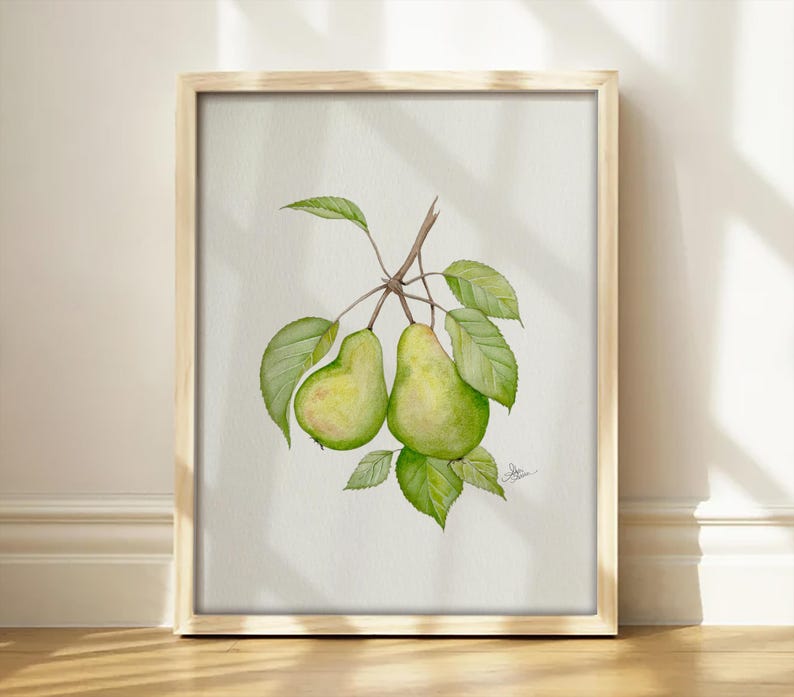 May include: A framed watercolor painting featuring two green pears hanging from a brown stem with several green leaves. The artwork is presented in a light-colored wooden frame, showcasing a botanical illustration of fruit on a white background.