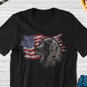 May include: Black t-shirt with a distressed American flag design and a black cocker spaniel dog silhouette.