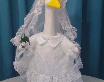 goose - wedding dress. Miss goose is ready to walk down the aisle into her new life . With a beautiful bouquet of flowers in her wing.