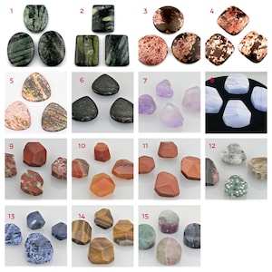 May include: Assortment of 15 different gemstone cabochons in various shapes and colors, including green, red, brown, purple, blue, and orange. The cabochons are displayed in rows on a white background.