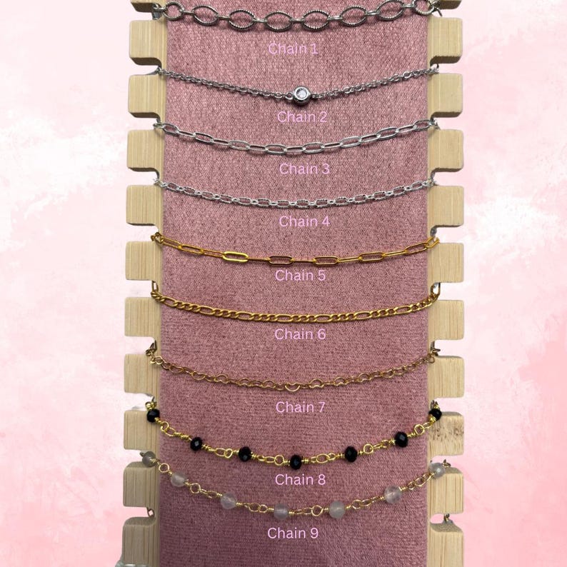 May include: Nine different chain styles displayed on a pink background. The chains are arranged vertically, with the top chain being the most delicate and the bottom chain being the most substantial. The chains are labelled with numbers 1 through 9.