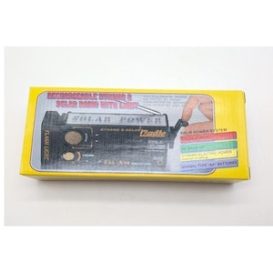May include: A yellow rectangular product box for a rechargeable dynamo and solar radio with light. The box features an illustration of the black radio, a hand operating the crank, and text listing four power systems: solar, DC, dynamo, and AA batteries.