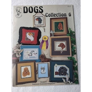 May include: A book cover with the title "Dogs Collection 6" featuring a variety of dog breeds in cross-stitch patterns. The cover is decorated with a floral border and a ribbon.