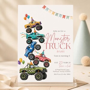 May include: A rectangular party invitation featuring a vertical stack of five colorful monster trucks with party hats and balloons. The text reads: Join us for a Monster TRUCK BASH, Tom is turning 5, SAT 23 MARCH, Three o'clock, 12 Mud Truck Lane.