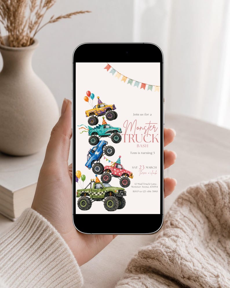 May include: A digital invitation displayed on a smartphone screen featuring a stack of five colorful monster trucks with party hats and balloons. The text reads Join us for a Monster Truck Bash, Tom is turning 5, SAT 23 MARCH, and event details.