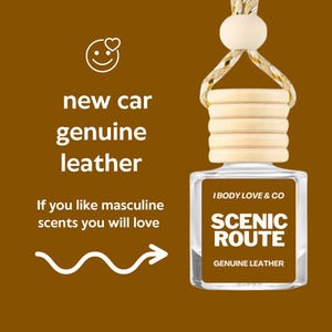 May include: A clear, rectangular car air freshener with a wooden cap and a decorative string. The label reads "SCENIC ROUTE" and "GENUINE LEATHER". The text "new car genuine leather" is also visible.