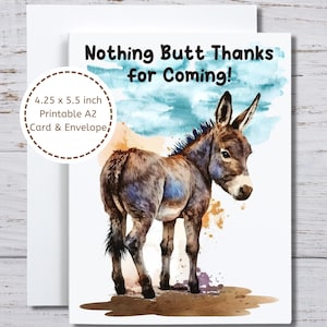 May include: A greeting card with a watercolor illustration of a donkey. The card reads "Nothing Butt Thanks for Coming!" and includes the dimensions 4.25 x 5.5 inches. The card is paired with a white envelope.