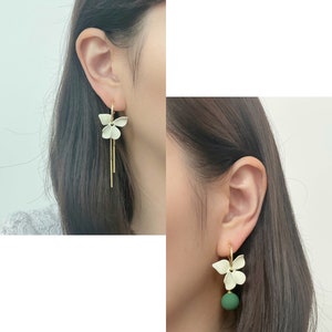 Mismatched white flower dangle clip on earrings with matte green ball and gold chains, invisible clip on earrings image 2