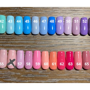 May include: A row of 11 small bottles of nail polish in shades of blue, purple, and pink, followed by a row of 11 small bottles of nail polish in shades of pink, orange, and red. The bottles are numbered 41 through 66.