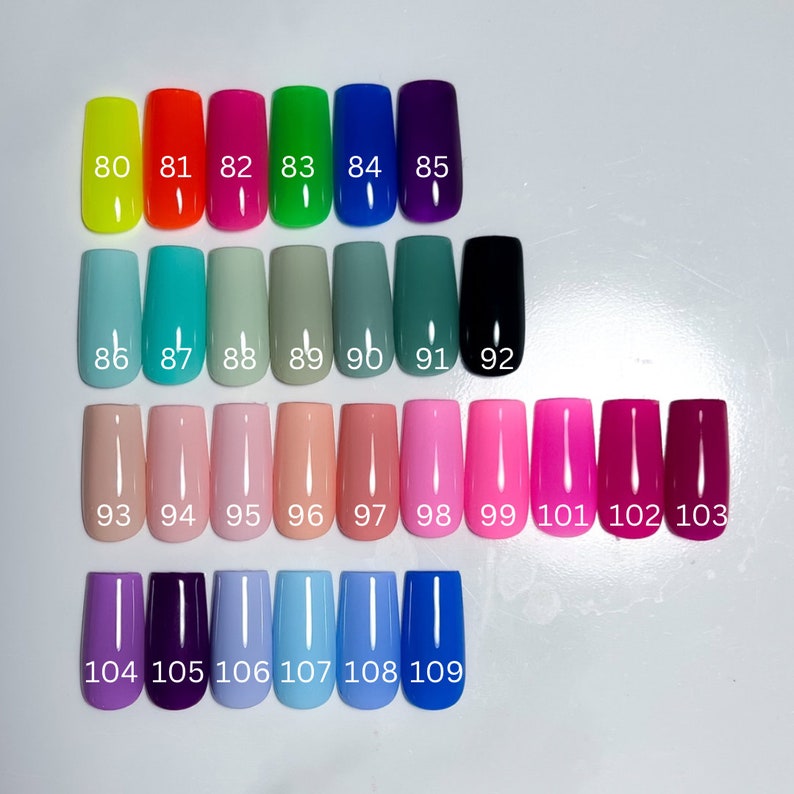 May include: A color chart of 19 different nail polish colors, numbered 80 through 109. The colors include neon yellow, orange, pink, green, blue, purple, teal, sage green, black, peach, pink, coral, red, magenta, lavender, dark purple, light blue, sky blue, and royal blue.
