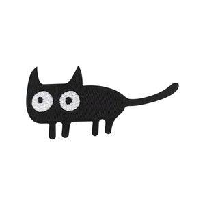 Könnte beinhalten: Schwarzer gestickter Bügel-Patch mit einem Cartoon-Katzenmotiv mit großen weißen Augen.