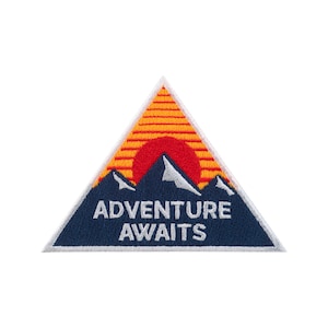 May include: A triangular patch featuring a mountain range silhouette with a red sun setting behind them. The patch has the words "ADVENTURE AWAITS" in white lettering on a navy blue background.