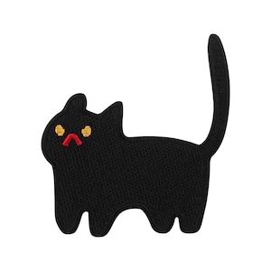 May include: A black cat-shaped patch with embroidered details. The cat has yellow eyes and a red mouth, with a slightly grumpy expression. The patch is likely for clothing or accessories.