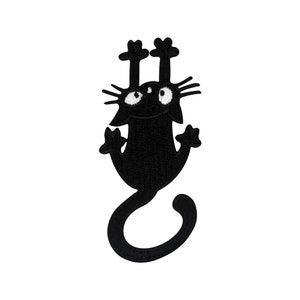 May include: Black embroidered iron-on patch of a cartoon cat hanging upside down with its paws in the air.