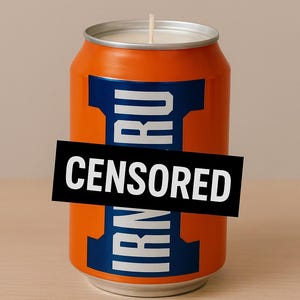 May include: Orange candle in the shape of a soda can, with blue and white accents. The text "IRN RU" is partially visible, with a black rectangle obscuring the rest of the text. A white wick is centered on the top.