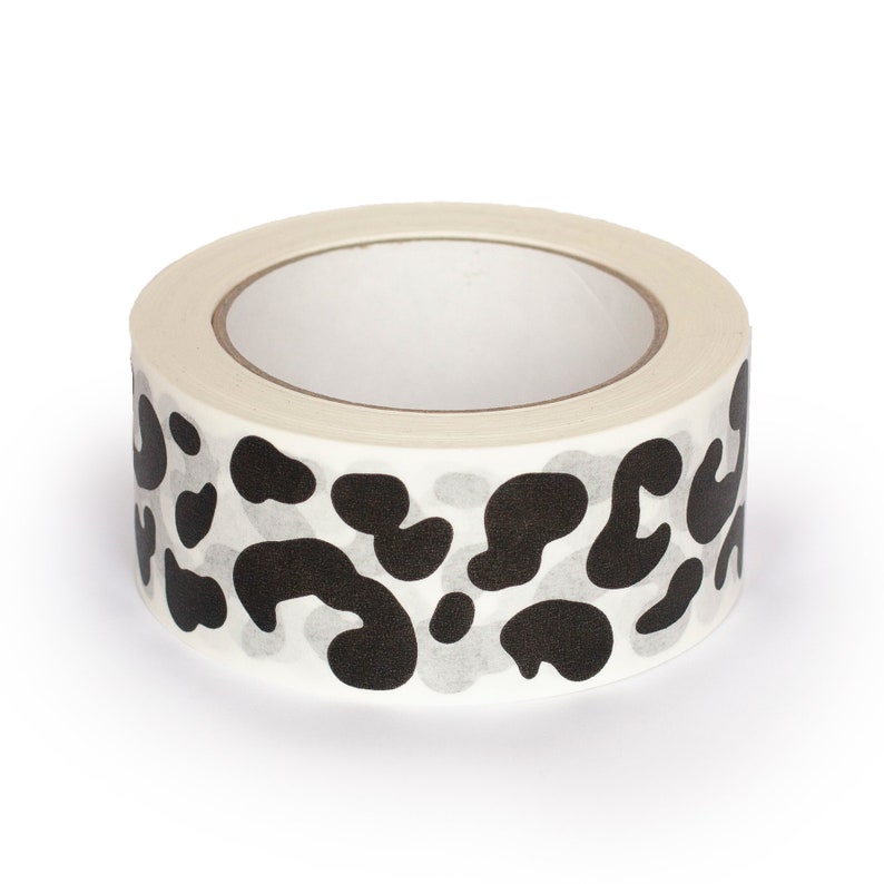 May include: A roll of white washi tape with a black leopard print design.