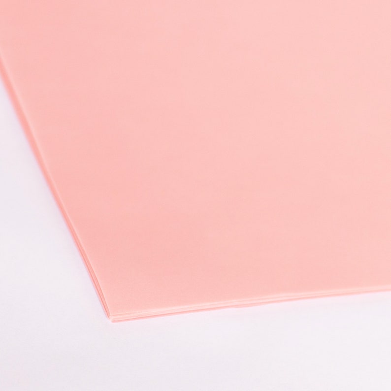 May include: A sheet of light pink tissue paper.