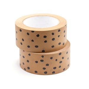 May include: Two rolls of brown packing tape with a black polka dot pattern.