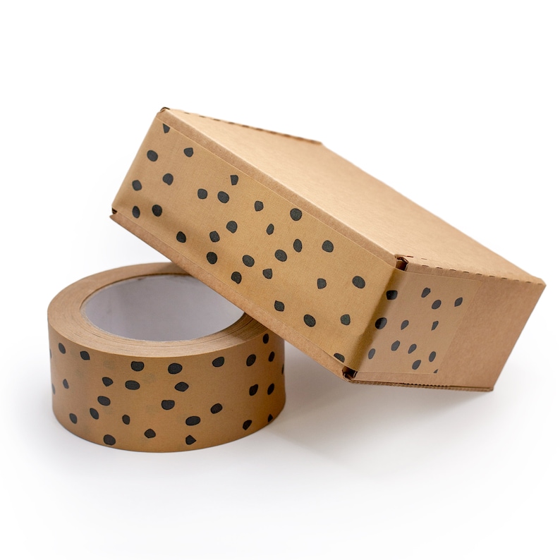 May include: A roll of brown packing tape with black polka dots and a brown cardboard box with black polka dots.