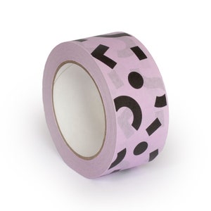 May include: A roll of pink tape with a black and white geometric pattern. The tape is on a white background.