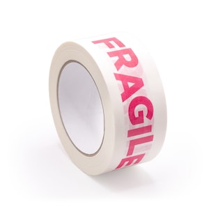 May include: A roll of white packing tape with the word "FRAGILE" printed in pink letters.