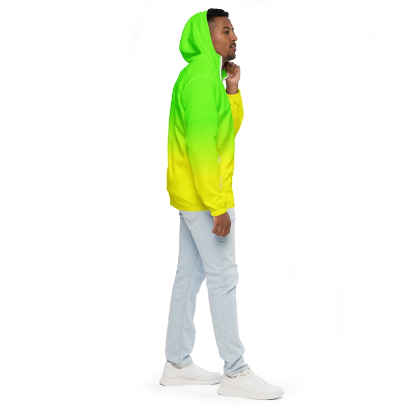 May include: A yellow and green gradient hooded jacket with a zipper closure. The jacket has a drawstring hood and a front pocket.