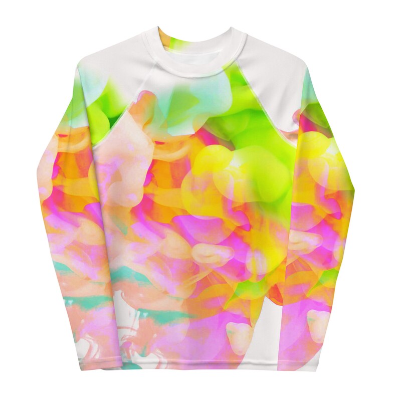 May include: A white long-sleeve shirt with a colorful abstract design featuring pink, yellow, green, and blue hues. The design is reminiscent of a watercolor painting.
