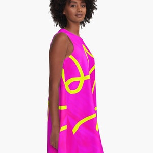 May include: A sleeveless dress with a bright pink background and yellow abstract lines.