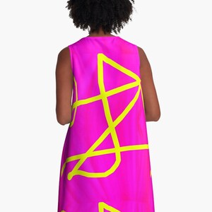 May include: A sleeveless pink dress with a yellow abstract design.