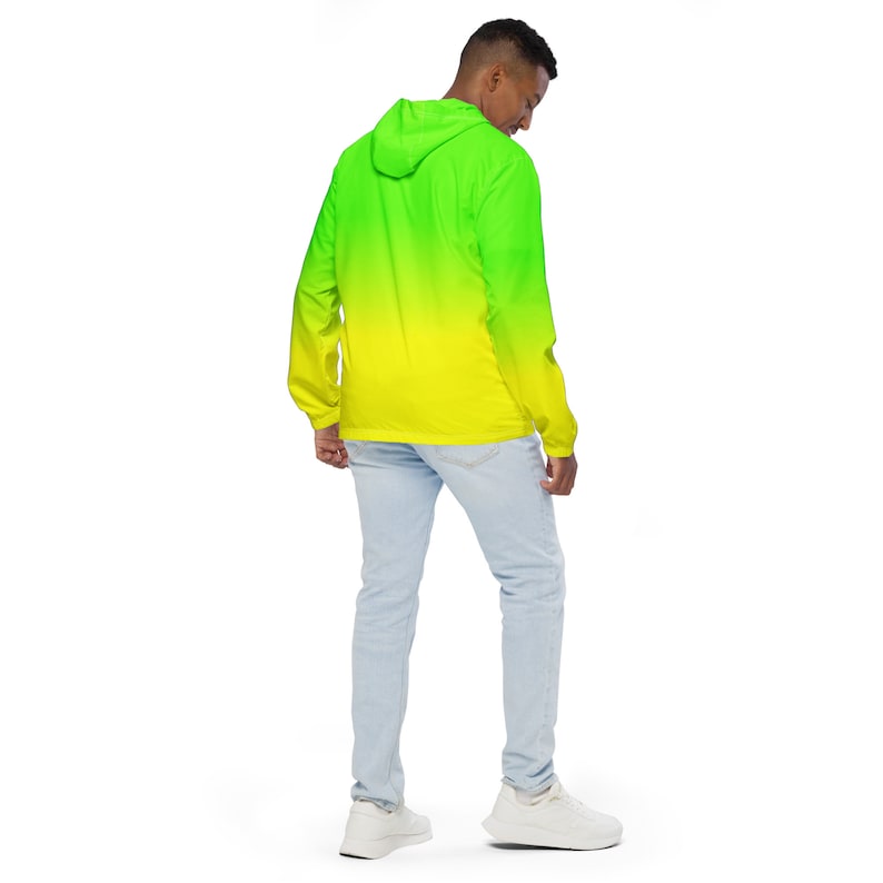 May include: A hooded jacket with a green to yellow ombre design. The jacket is made of a lightweight material and has a zipper closure.