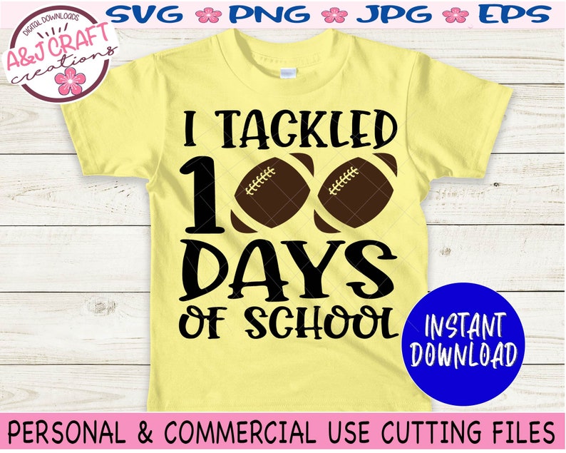 May include: A pale yellow short-sleeve t-shirt featuring the black text I TACKLED 100 DAYS OF SCHOOL with two brown footballs replacing the zeros in 100. The design is centered on the front of the shirt, which is displayed flat.