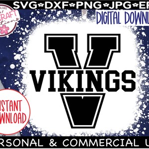 May include: A black and white graphic design of a stylized letter V with the word "VIKINGS" in black text below. The design is on a white background with a white splatter effect.