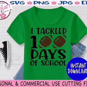 May include: A bright green short-sleeved t-shirt featuring the black text I TACKLED 100 DAYS OF SCHOOL with two brown footballs replacing the zeros in 100. The design is centered on the front of the shirt, which is displayed flat.