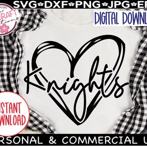 May include: A white t-shirt with a black heart design and the word "Knights" written inside the heart. The t-shirt is on a checkered background.