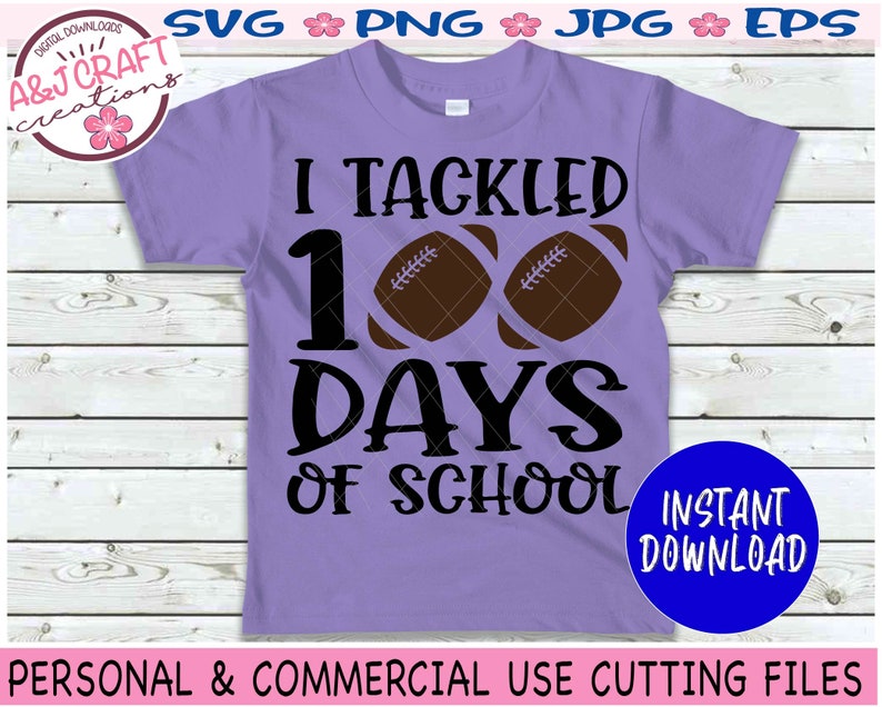 May include: A light purple t-shirt featuring the black text I TACKLED 100 DAYS OF SCHOOL with two brown football graphics replacing the zeros in 100. The design includes a circular logo in the top left corner and a blue circle in the bottom right.
